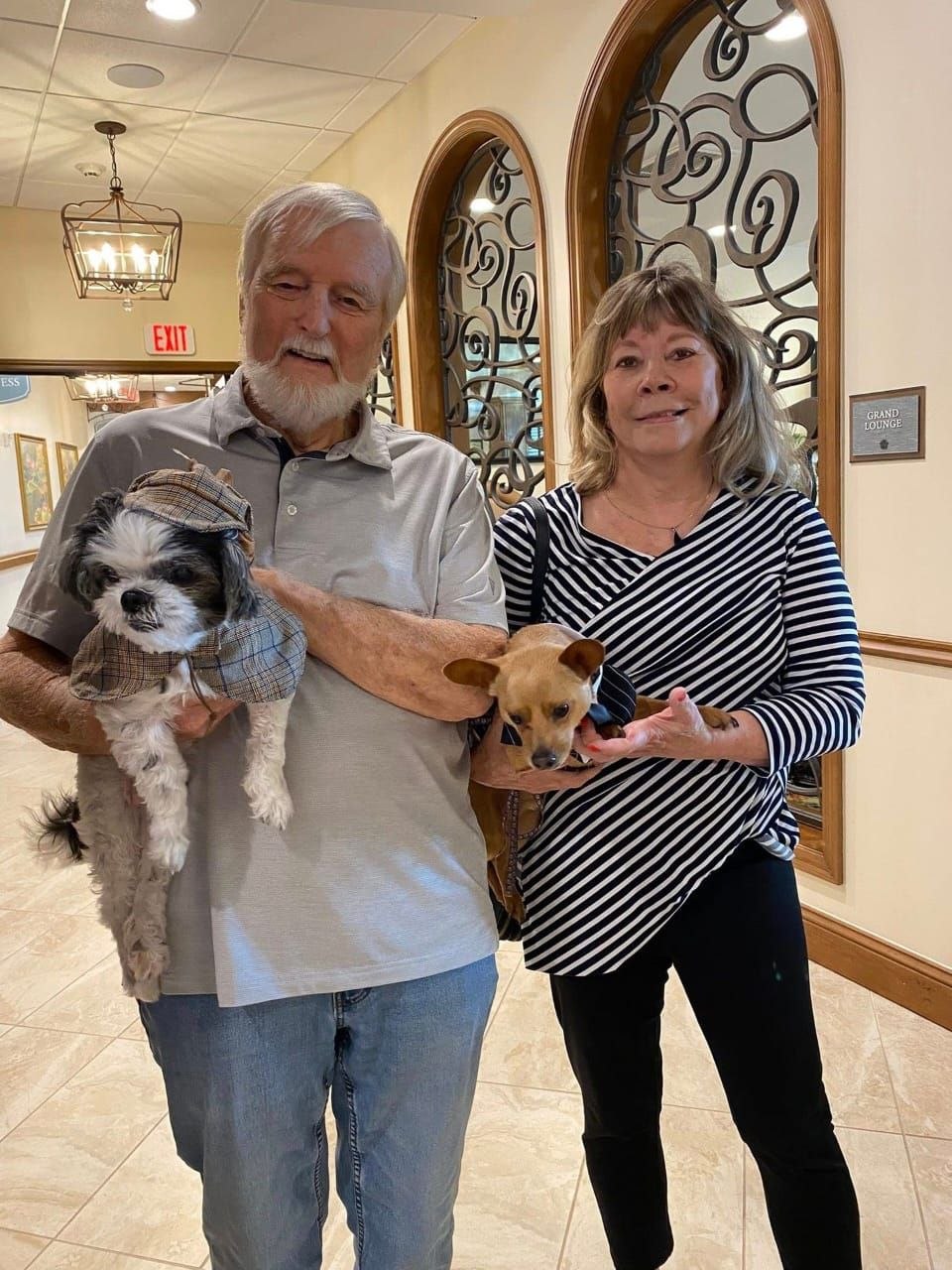 Happy pet owners with their dogs after delivery.